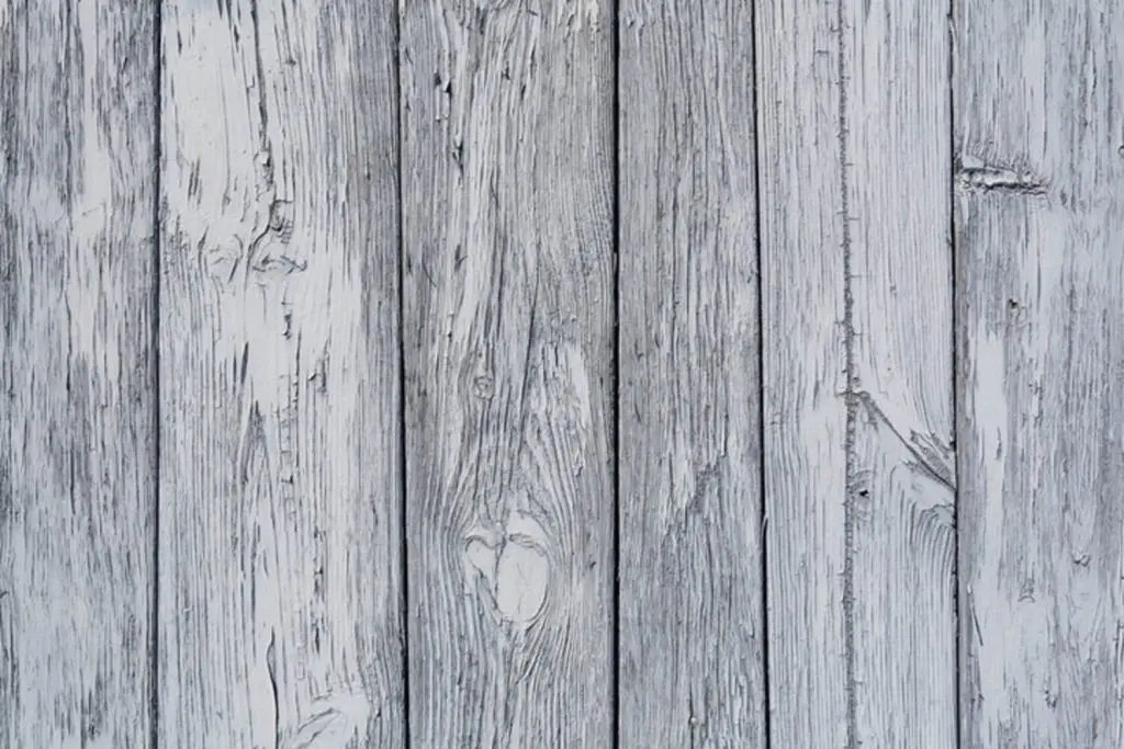 How long does fence stain last in Asheville NC — weathered gray wood fence boards showing UV fading and moisture damage