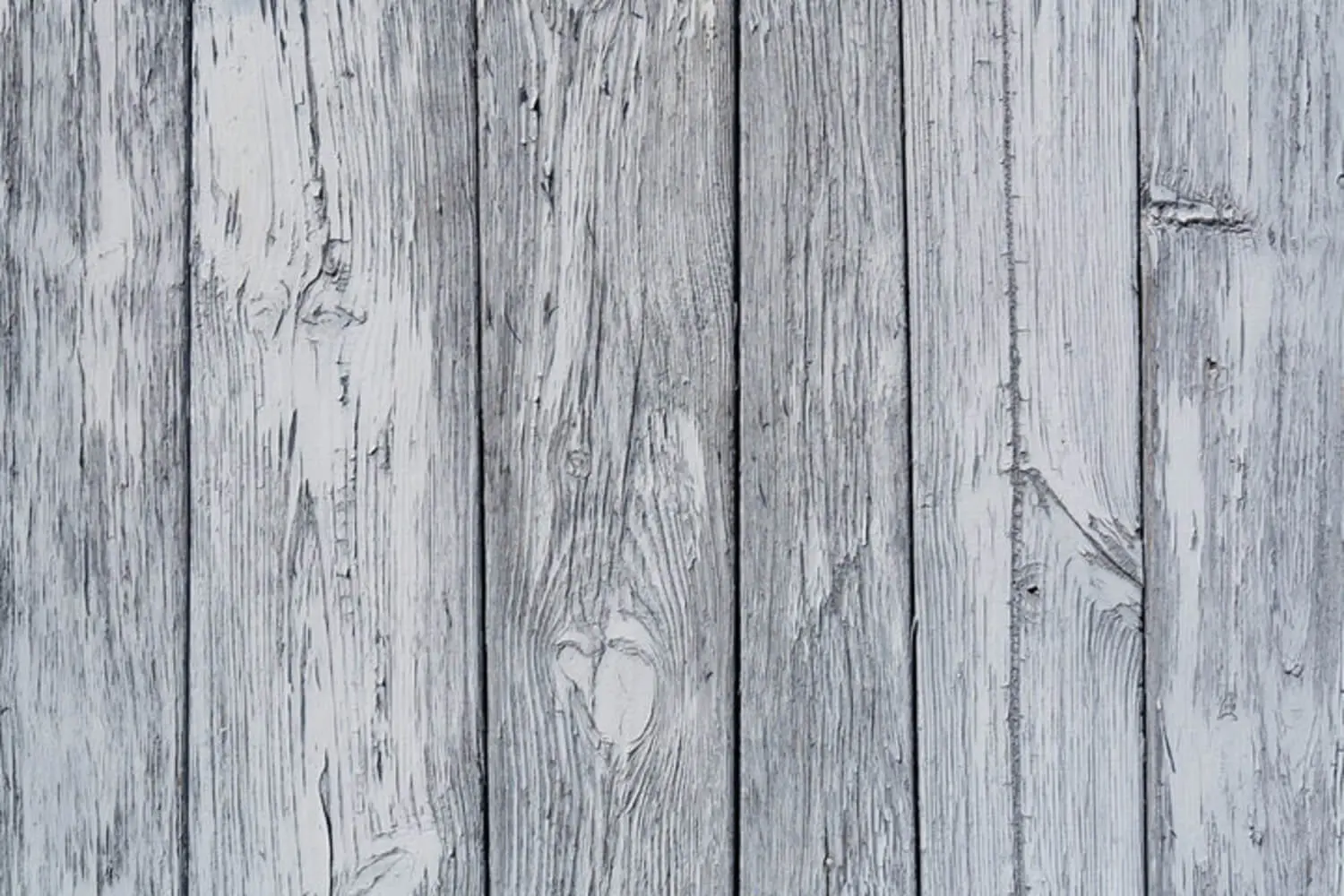 How long does fence stain last in Asheville NC — weathered gray wood fence boards showing UV fading and moisture damage
